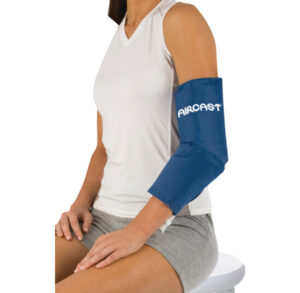Person wearing a blue blood pressure cuff on the arm.