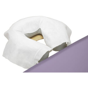 A white neck pillow with a strap on a purple surface.