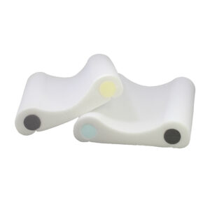 Two ergonomic white foam armrests with colored circular ends.