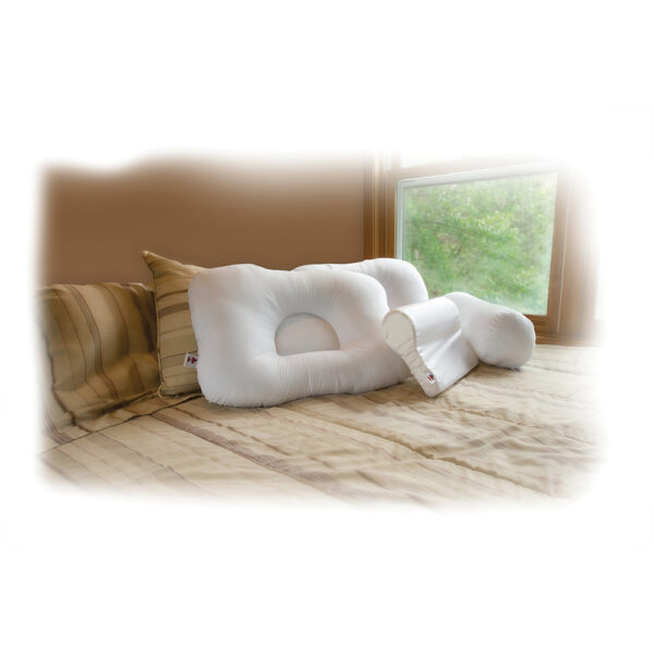 Two ergonomic memory foam pillows on a bed by a window.
