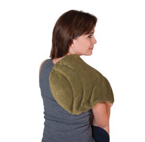Woman wearing an olive green neck and shoulder heating pad.