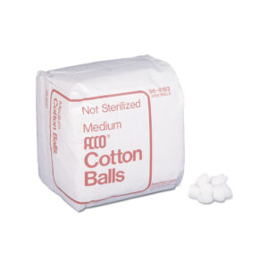 A pack of medium-sized cotton balls with some loose balls beside it.