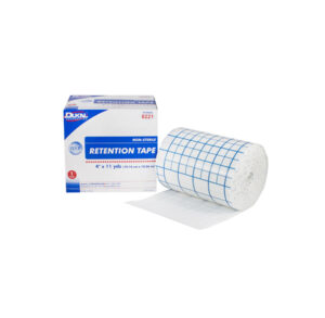 A roll of retention tape with grid markings next to its box.