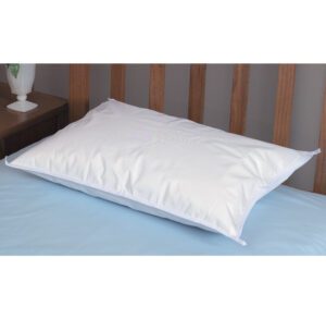 A white pillow on a blue bedsheet with a wooden headboard.