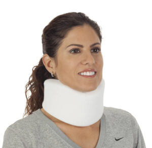 Woman wearing a white neck brace and gray sweater.