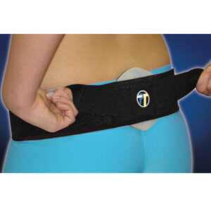 Person wearing a black back support belt over blue pants.
