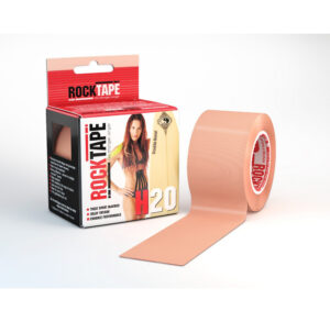 A roll of beige kinesiology tape next to its packaging box.