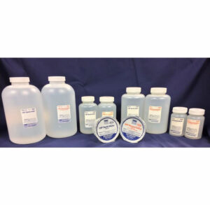 Various labeled chemical bottles and jars on a dark surface.