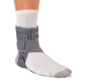 Ankle brace worn over a white sock for support.