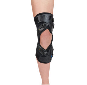Black adjustable knee brace worn on a leg for support.