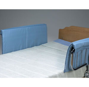 A hospital bed with blue padded side rails and a wooden headboard.